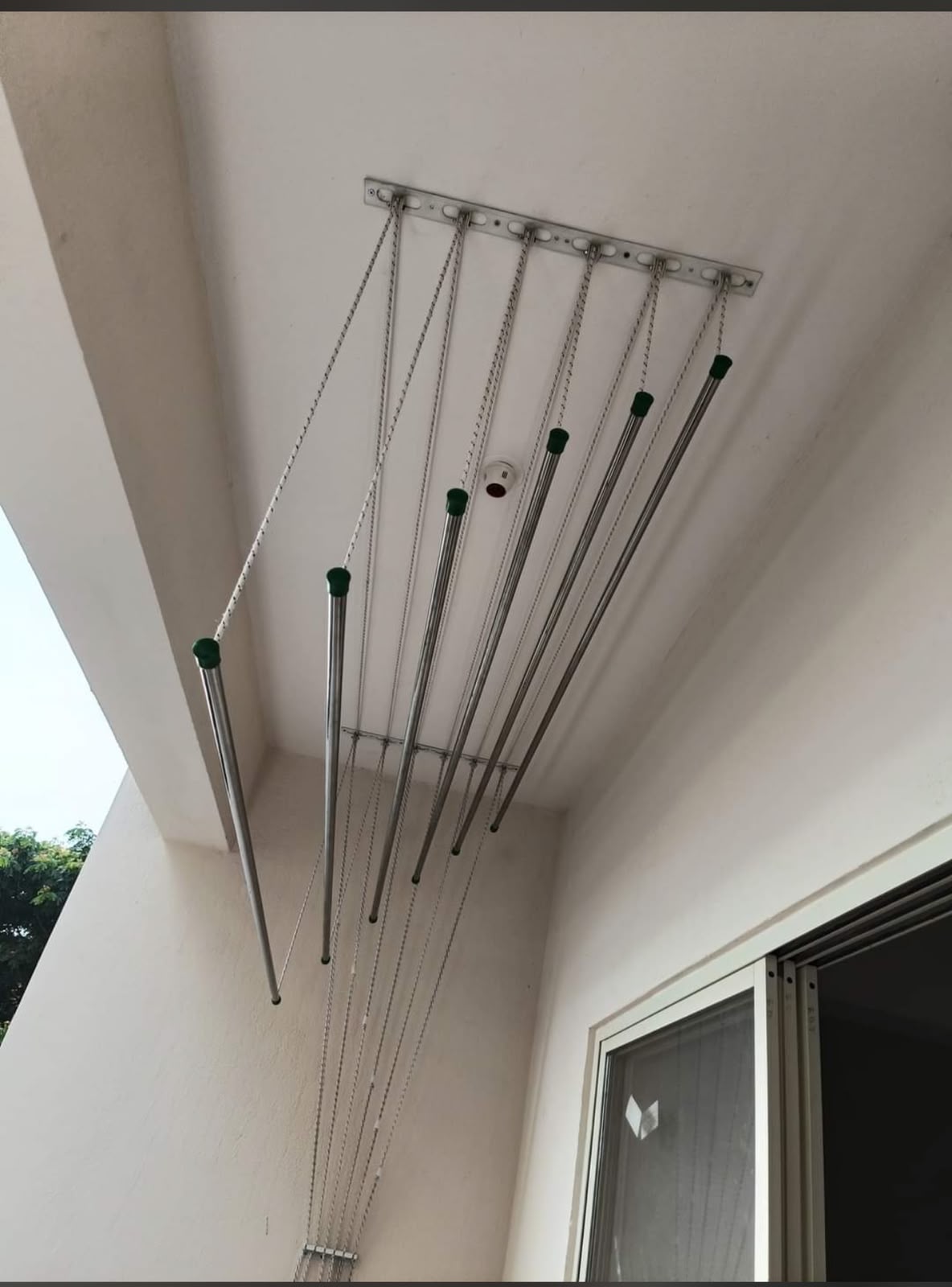 Ceiling-mounted cloth drying hanger installed in a balcony