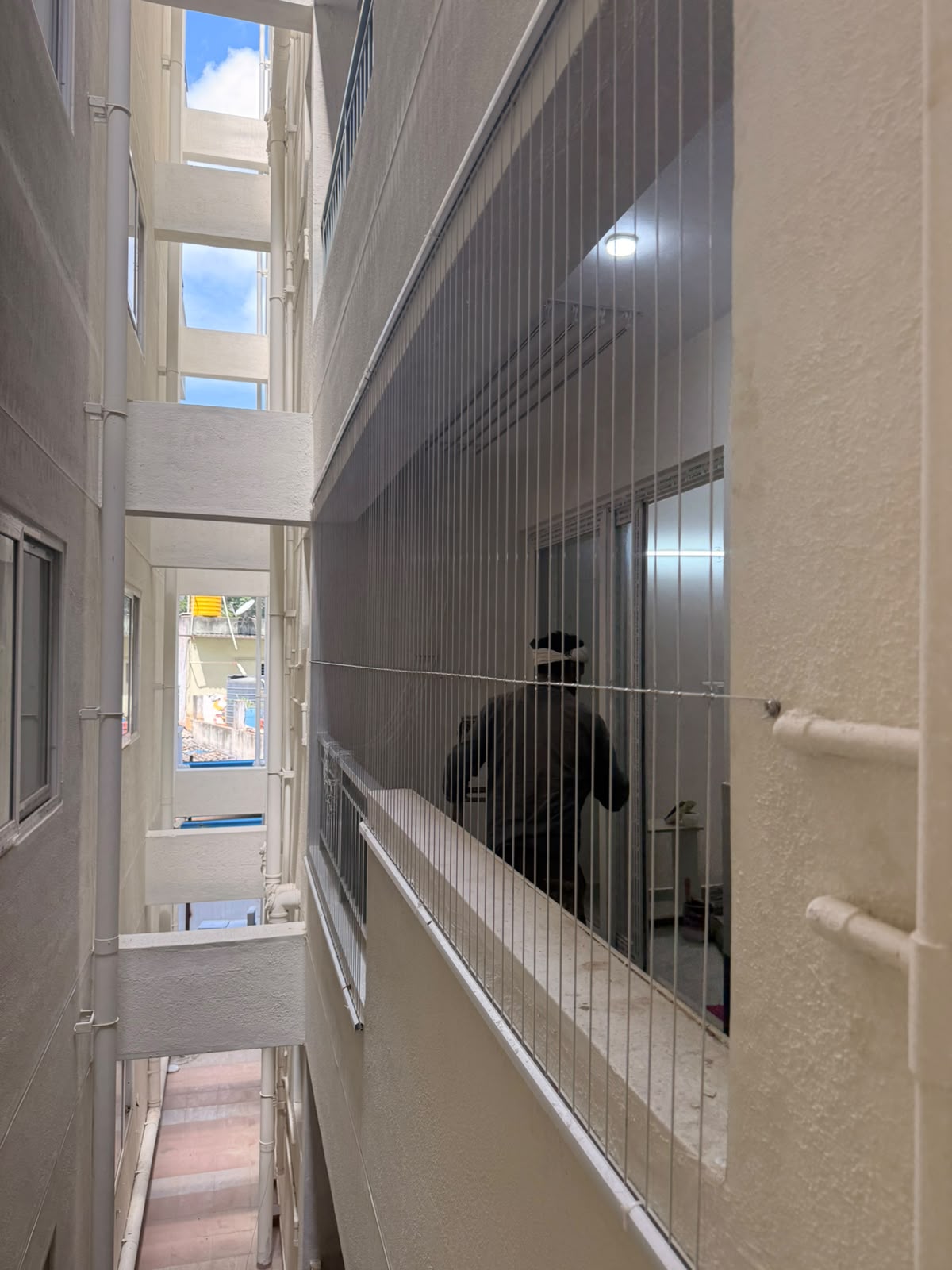 Invisible grille netting installed on a balcony duct area