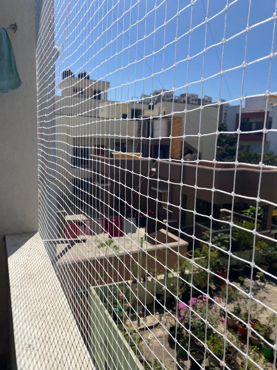 White pigeon safety net fitted on a residential balcony