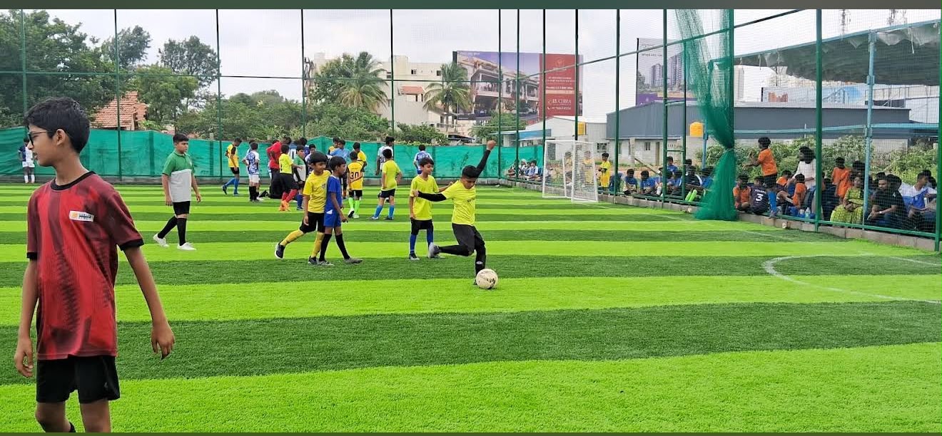 Football turf surrounded by tall boundary safety nets
