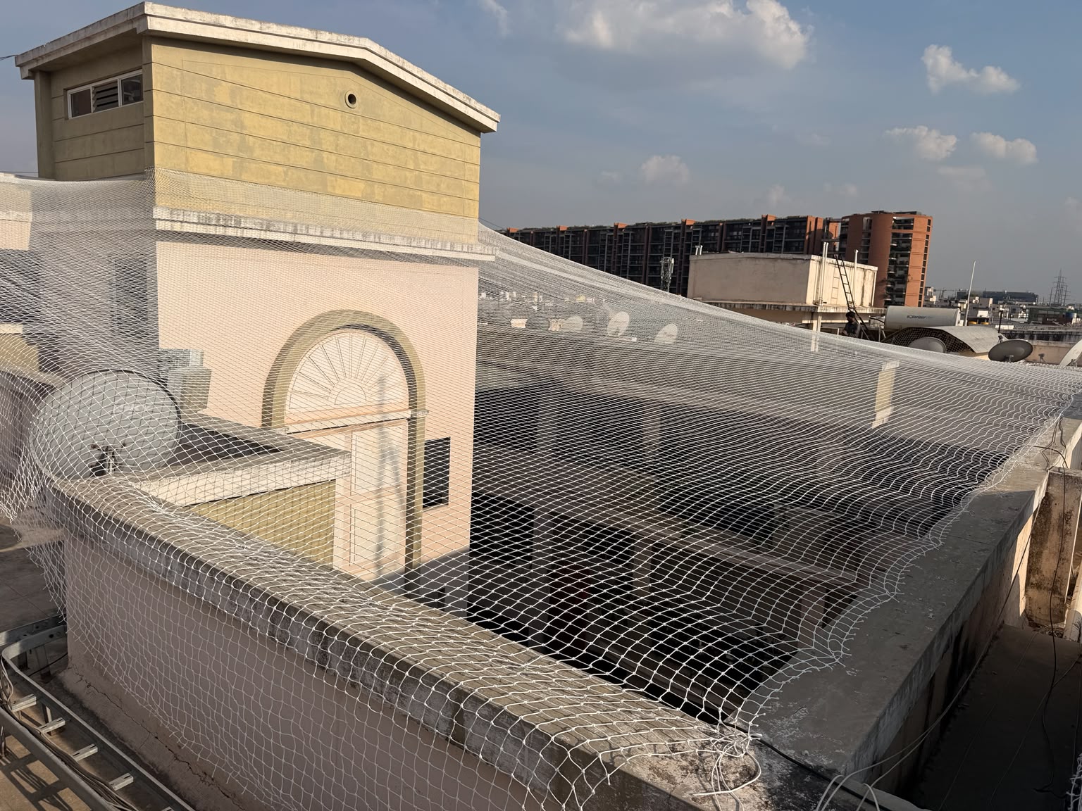 White pigeon net covering an open terrace of a building